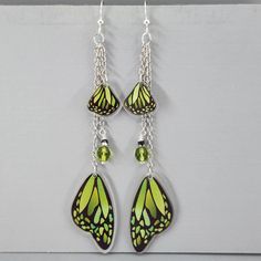 Butterfly Wing Earrings Green Monarch Butterfly Wings Earrings Long Dangle Drop Earrings Magical Fairy Wing Earrings Colorful Wing Earrings I ship super fast.  These super fun lightweight earrings are so pretty. The beads are wire wrapped and connected to the chain.  The wings are connected to the chain.  They are all gathered on a jumpring and connected to the ear wires. The wings are made of resin.  They are double-sided.  The beads are glass crystals.  The chain is non-tranish silver plated a