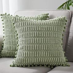 two green pillows sitting on top of a couch