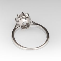 This classic vintage 1950s solitaire ring is crafted of 18k white gold and now holds a 1.01ct lab grown diamond that is IGI certified and grades E in color and VVS2 in clarity. The ring is currently a size 4. EraGem lab diamond rings will arrive with an in-store certification as well as the IGI report and a lovely EraGem logo presentation box. Timeless Solitaire Cluster Ring In White Gold, Timeless White Gold Solitaire Cluster Ring, Classic Solitaire Halo Ring For Formal Occasions, Classic Moissanite Solitaire Halo Ring, Timeless Platinum Halo Ring With Brilliant Cut, Classic Cluster Ring With Prong Setting Lab Grown Diamond, Classic Lab Grown Diamond Cluster Ring Brilliant Cut, Timeless Platinum Diamond Ring For Proposal, Asscher Cut Brilliant Cluster Ring For Anniversary