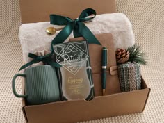 a gift box filled with personal items such as coffee mugs and pens