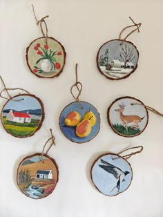 six hand painted ornaments hanging from twine