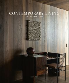 the cover of contemporary living yearbook 2012, featuring a desk and chair in front of wood paneled walls