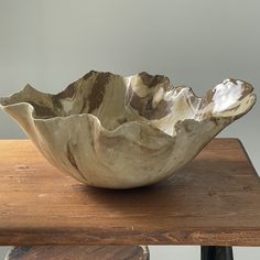 a bowl sitting on top of a wooden table