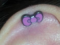 an ear with two pink bows on it