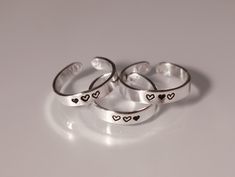 This ring set features hearts and is great for you and your best friend, or your whole friend group! This heart ring set is available in quantities of 2, 3, 4, 5, 6, 7, or 8, making it the perfect ring set for your group of friends. Product Details: Materials: Sterling Silver Color: Silver Size: 3mm Matching Rings You will receive hand-stamped rings filled with a black enamel finish. 3 Matching Rings, Bff Rings 3, Matching Rings For 3 Best Friends, Friendship Jewelry For 3, Best Friend Rings For 3 Friendship, Matching Rings For Sisters, Matching Trio Jewelry, Friendship Rings For 4 Friends, 3 Best Friend Bracelets