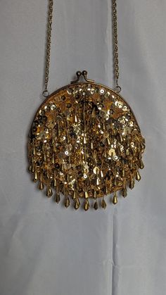 This beaded handbag is in great shape, lots of fine details and has a great sparkle when the light hits it.  Chain/strap is gold and 20 inches.  Made in Macau Gold Evening Bag With Gold Embroidery For Festive Occasions, Gold Sequined Shoulder Bag For Evening, Vintage Embellished Bag For Festive Occasions, Vintage Embellished Bags For Festive Occasions, Festive Gold Clutch With Gold Embroidery, Gold Beaded Bag For Festive Occasions, Handmade Vintage Evening Bag For Festive Occasions, Festive Gold Bag With Gold Beads, Vintage Handmade Evening Bag For Festive Occasions