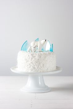 a cake with white frosting and sheep on top