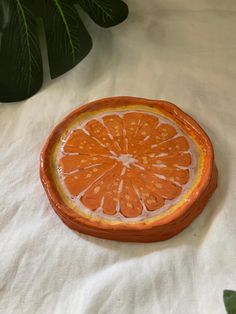 Introducing the Orange Trinket Tray, expertly crafted from the finest air dry terra cotta. Each tray is hand sculpted and hand drawn with acrylic markers, giving it a unique organic shape. Use it as the perfect jewelry organizer, clear coated for maximum durability. Elevate your organization game now! Size 9cm diameter Orange Trinket Dish, Fruit Trinket Dish, Cute Trinket Tray, Air Clay Tray, Homemade Trinket Dish, Air Dry Trinket Dish, Trinket Tray Painting Ideas, Air Dry Clay Trinkets, Air Dry Clay Jewelry Dish