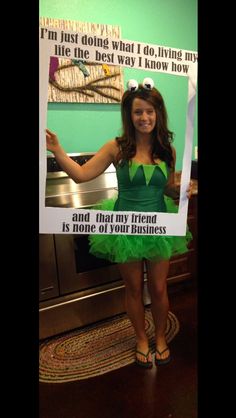 a woman in a green dress holding up a sign