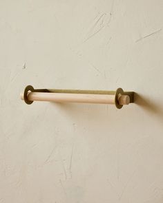 a wooden handle on a white wall