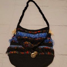 a black purse with multicolored fringes on it