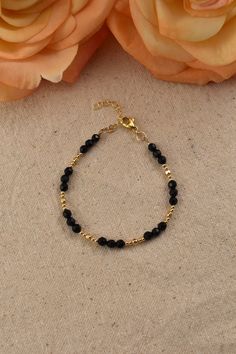 Black Onyx Bead Bracelet, 14Kt Gold Filled - Gemstone Jewelry Gifts for Women Adjustable 7 inches - 8 inches Black and gold create a perfectly elegant combination. This bracelet is easy to match with any outfit, adding an effortless elegance. You will love the bright sparkle of the gold beads, and the flashes from the dark surfaces of the faceted Onyx beads.  What is Gold Filled? Gold filled jewelry has a layer of solid gold that is 100 times thicker than that of gold plated jewelry. It is hypoallergenic, resistant to tarnish, and will not chip or fade over time. Gold filled has an appearance nearly identical to solid gold, but with a more affordable price. It is highly durable and with proper care will last a lifetime. Browse my shop: ALLDANAE.etsy.com Black Bracelet With Gold Beads, Dainty Black Beaded Bracelets For Gift, Gold Crystal Bracelet With Round Black Beads, Gold Bracelet With Black Beads Jewelry, Gold Bracelet Jewelry With Black Beads, Dainty Adjustable Black Beaded Jewelry, Hand-strung Onyx Jewelry In Gold, Gold Beaded Bracelets With Onyx Gemstones, Gold Crystal Bracelet With Round Beads And Beaded Chain