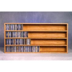 a wooden shelf with several dvd's on it and two rows of dvds in the middle