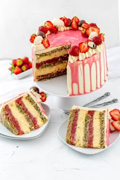 the cake is decorated with strawberries and other desserts on plates next to it