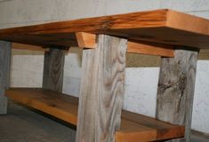 two wooden benches sitting next to each other in a room with cement walls and concrete flooring