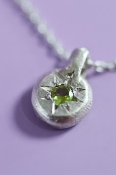 The delicate Fay Peridot pendant is the perfect way to add a touch of elegance to your everyday look. Crafted with Sterling Silver and a star-set Peridot, perfect for adding a bit of mystical charm. Use the drop down to select your chain preference. Details925 Sterling SilverRound cut PeridotHandcrafted in our studioEach piece is handmade so please allow for minor differences in texture and colour.Item #9904-01