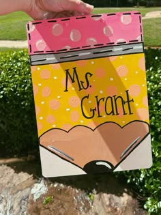 a hand holding up a sign that says, ms grant