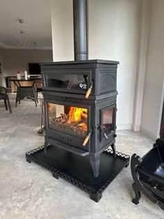 a black stove sitting in the middle of a living room