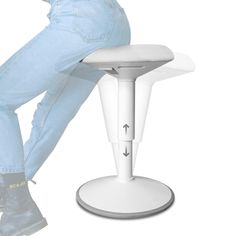 a person sitting on a stool with their legs crossed and feet up in the air