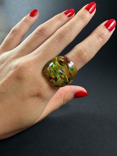 Adorn your fingers with the vibrant beauty of Handblown Glass Rings, meticulously crafted in Malta. Each ring is a unique work of art, featuring smooth, rounded edges for a comfortable fit. The rich, bold colors make these rings truly stand out, adding a touch of individuality to any outfit. Perfect for those who appreciate finely crafted jewelry, these glass rings are as durable as they are stunning.    Sizes are all in US metrics, shown in the first picture  Weight : 8g - 13g    The order of the variations is left to right, top to bottom. Ex. the ring in upper left corner is no.1, the ring in downer right corner is no.23    For each sale we plant a tree :) Plant A Tree, Glass Ring, Glass Rings, Crafted Jewelry, Slovakia, Everyday Jewelry, Hand Blown Glass, Malta, One Pic