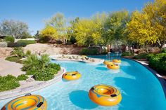 an inflatable pool with yellow rafts and trees