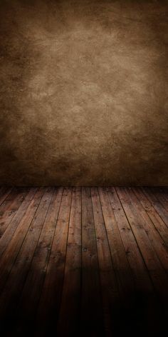 an empty room with wooden floors and a brown wall