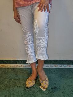 Soft Pure cotton Slim Pants with tassel trims and embroidered in chikankari. Side Pockets. Length - S - 37 inches M - 37 inches L - 38 inches XL - 38 inches XXL - 39 inches Size - S - waist stretched fits upto 40 M - waist stretched fits upto 42 L - waist stretched fits upto 44 XL - waist stretched fits upto 46 XXL - waist stretched fits upto 48/50 White Traditional Sets With Tassels, Traditional White Sets With Tassels, White Bohemian Straight Leg Pants, Fitted Straight Pants With Resham Embroidery, Traditional Embroidered Ankle-length Bottoms, Festive Pants With Embroidered Border For Spring, Bohemian White Pants With Floral Embroidery, Traditional Festive Spring Bottoms, Spring Cotton Pants With Tassels