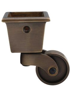 an old fashioned toilet paper roller with a cup on the top and wheels attached to it