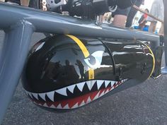 a close up of a motorcycle helmet on the back of it's bike frame