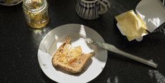 a piece of toast on a plate with butter