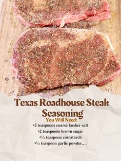 two steaks sitting on top of a cutting board with seasoning in front of them