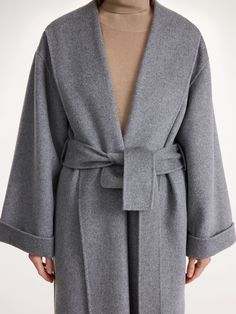 This classic wool-blend coat fits loosely, allowing layers to be worn underneath the longline style. The subtle shawl collar adds a soft element to the otherwise clean-cut coat. Wear your with tonal layers. Fall Cashmere Outerwear With Shawl Collar, Oversized Wool Outerwear With Shawl Collar, Classic Cashmere Outerwear With Shawl Collar, Chic Long Cashmere Outerwear, Classic Oversized Cashmere Outerwear, Chic Long Cashmere Coat, Oversized Elegant Wool Coat For Formal Occasions, Solid Cashmere Long Coat, Elegant Oversized Wool Coat