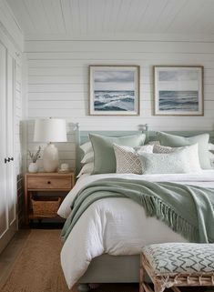 a bedroom with two pictures above the bed