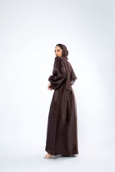 The Organza Abaya is statement outfit for any event. It's super lightweight yet so simple with the prettiest sheen. Complete the look with our matching long sleeve satin slip dress and a pair of strappy heels for a luxe finish or make it into a more casual look. *Please note that the color displayed in the picture might be slightly different due to the color resolution and lighting. Fabric Description & Care: Balloon Sleeves with elastic cuff Double Lined Material: Silk/Organza Dry Clean for bes Elegant Satin Abaya For Party, Evening Satin Maxi Abaya, Evening Satin Maxi-length Abaya, Eid Long Sleeve Satin Dress, Long Sleeve Satin Dress For Eid, Elegant Satin Maxi Abaya, Silk Maxi Dress With Sheer Sleeves, Silk Maxi Abaya For Party, Elegant Silk Maxi Abaya