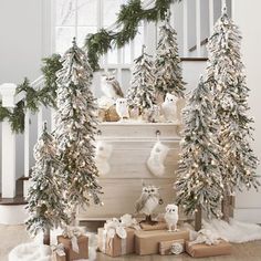 christmas decorations on the banisters in front of a staircase with presents under them