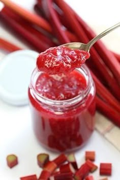 a spoon full of cranberry sauce sitting on top of red rhubars