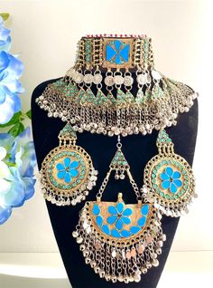 Full light blue firuza Afghan jewellery set, Afghan Jewellery Vintage Kuchi Choker Necklace, Afghan Jewellery, Afghan Fashion  Set includes:  -oversized tikka -chocker necklace  -oversized earrings  Message for any enquiries Our Aim as a business is to connect Afghan women with their roots and to make anyone that purchases our jewellery feel powerful and beautiful as each and everyone of our items is handcrafted with care and love. Blue Bohemian Wedding Sets, Traditional Blue Jewelry Sets, Bohemian Light Blue Jewelry For Festivals, Handmade Light Blue Jewelry For Party, Blue Jewelry For Party Festivals, Vintage Light Blue Handmade Jewelry, Traditional Turquoise Jewelry Sets As Gift, Traditional Turquoise Jewelry Set For Gift, Traditional Turquoise Jewelry Sets For Festive Occasions