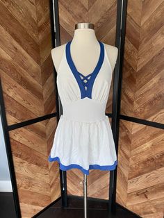 1970's white halter top one piece swimsuit with blue details and skirt overlay. Very cute neckline details. Padding on the bust has completely disintegrated and the crumbles are still in the lining. Orange storage spots all along the back waist. Stetched threads under the bust Women's medium 35" bust 29" waist (could be let out an inch) 38-40" hips 27.5" shoulder to skirt hem 16" rise Orange Storage, One Piece Skirt, Neckline Details, Sailor Style, White Halter Top, Skirt Swimsuit, Sailor Fashion, Halter Tops, One Piece For Women