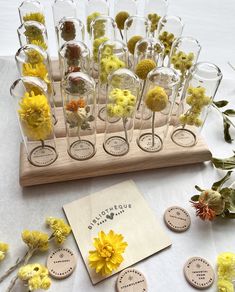 a table topped with lots of glass vases filled with flowers