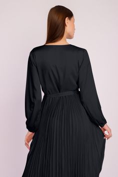 Our stunning Long Sleeve Pleated Satin Maxi Dress is an elegant and fashionable addition to your evening wear collection. Featuring long puffed sleeves, a crossover front with a dainty waist tie, and a long pleated satin skirt, this beautiful ensemble is the ideal choice for any party or formal event. Formal V-neck Belted Dress With Tie Waist, Chic V-neck Dress With Belt, Satin Wrap Dress For Work, Formal V-neck Mini Dress With Pleated Sleeves, Satin V-neck Dress With Pleated Sleeves, Satin Midi Dress With Tie Waist For Evening, Formal Satin V-neck Mini Dress, Dressy Satin V-neck Mini Dress, Dressy Satin Mini Dress With V-neck