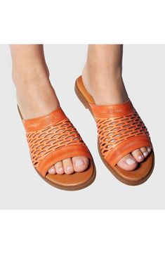 Add the perfect finishing touch to your warm-weather looks in this slide sandal fitted with a cushioned footbed to keep you stepping comfortably. A rich leather upper in a netted design encases your foot for ultimate support. 1" heel Leather upper and lining/rubber sole Imported Comfortable Orange Slides With Round Toe, Comfortable Orange Round Toe Slides, Orange Leather Slip-on Sandals, Orange Leather Sandals For Summer, Comfortable Slip-on Sandals With Textured Sole, Spring Closed Toe Slides With Leather Sole, Orange Cushioned Slip-on Sandals, Comfortable Orange Slide Sandals, Comfortable Open Toe Mules With Woven Sole