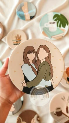 a person holding a plate with two people on it, surrounded by coffee cups and saucers