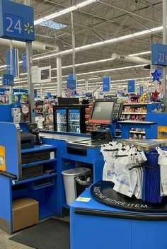 the inside of a store with blue counters and bins full of items in it