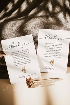 two wedding thank cards sitting on top of a table