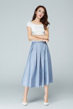 "Spring has sprung in this blue midi skirt from Xiaolizi. The linen skirt built in a high-rise, A-line silhouette with pleating throughout. The summer circle skirt topped with a banded waist + two seam pockets. DETAIL * 50% linen, 50% cotton * No lining * Seam pocket * Back zipper closure * Below Knee Length * Pleated Skirt * Perfect for summer, spring * Wash by hand or machine with cold water * The model is 163cm (5′4″) tall with a 80cm (31.5\") bust, 66cm (26\") waist. She is wearing the blue Light Blue Skirt With Pockets, Blue Casual Pleated Skirt With Pockets, Casual Blue Pleated Skirt With Pockets, Summer Midi-length Pleated Skirt, Light Blue Long Skirt For Summer, Light Blue Summer Skirt With Pockets, Spring Blue Pleated Midi Skirt, Spring Casual Pleated Skirt With Pockets, Casual Spring Pleated Skirt With Pockets