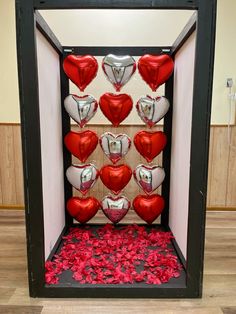 a display case filled with lots of red and white heart balloons