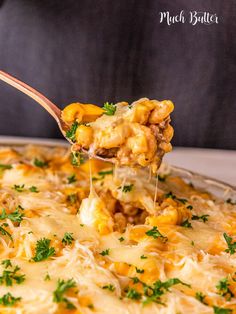 a spoonful of macaroni and cheese being lifted from a casserole dish