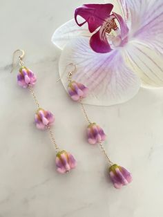 Handmade with Aloha!  Pua kalaunu, otherwise known as crown flower, was a favorite of Queen Lili'uokalani.  We've created jewelry using faux pua kalaunu beads. They are very lightweight and look like the real flower. Approximately 3.25 inches long Flower Drop Earrings, Crown Flower, Crescent Moon Earrings, Doll Jewelry, Amethyst Earrings, Moon Earrings, Pearl Stud Earrings, Pearl Studs, Flower Jewellery