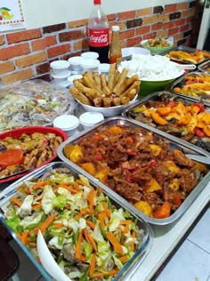 a buffet table filled with lots of food and condiments on top of it