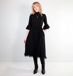 "Made from a luxurious blend of bamboo, cotton and a little elastane for good measure. This fabric is breathable, moisture-wicking, and machine washable, with an incredible drape. We don't mind if you spill the tea in our new Kiki Dress (it's machine washable). This tea length dress features a high lace mock-neck, and ¾ length lace-trimmed sleeves that flutter softly across the forearm. The full, gathered skirt panels are trimmed in our double-stacked lace for dramatic flare. Made from our signa Kiki Dress, Full Gathered Skirt, Spill The Tea, Tea Length Dress, Organic Fashion, Nova Scotia Canada, Tea Length Dresses, Gathered Skirt, Tea Length